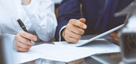 Two people writing and reading documents